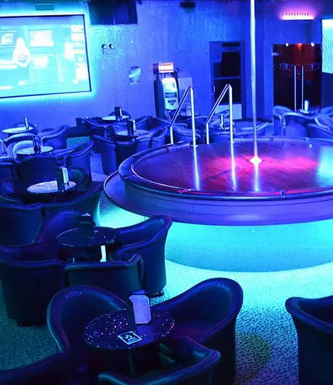 Indoor party area with a circular stage and plush seating.